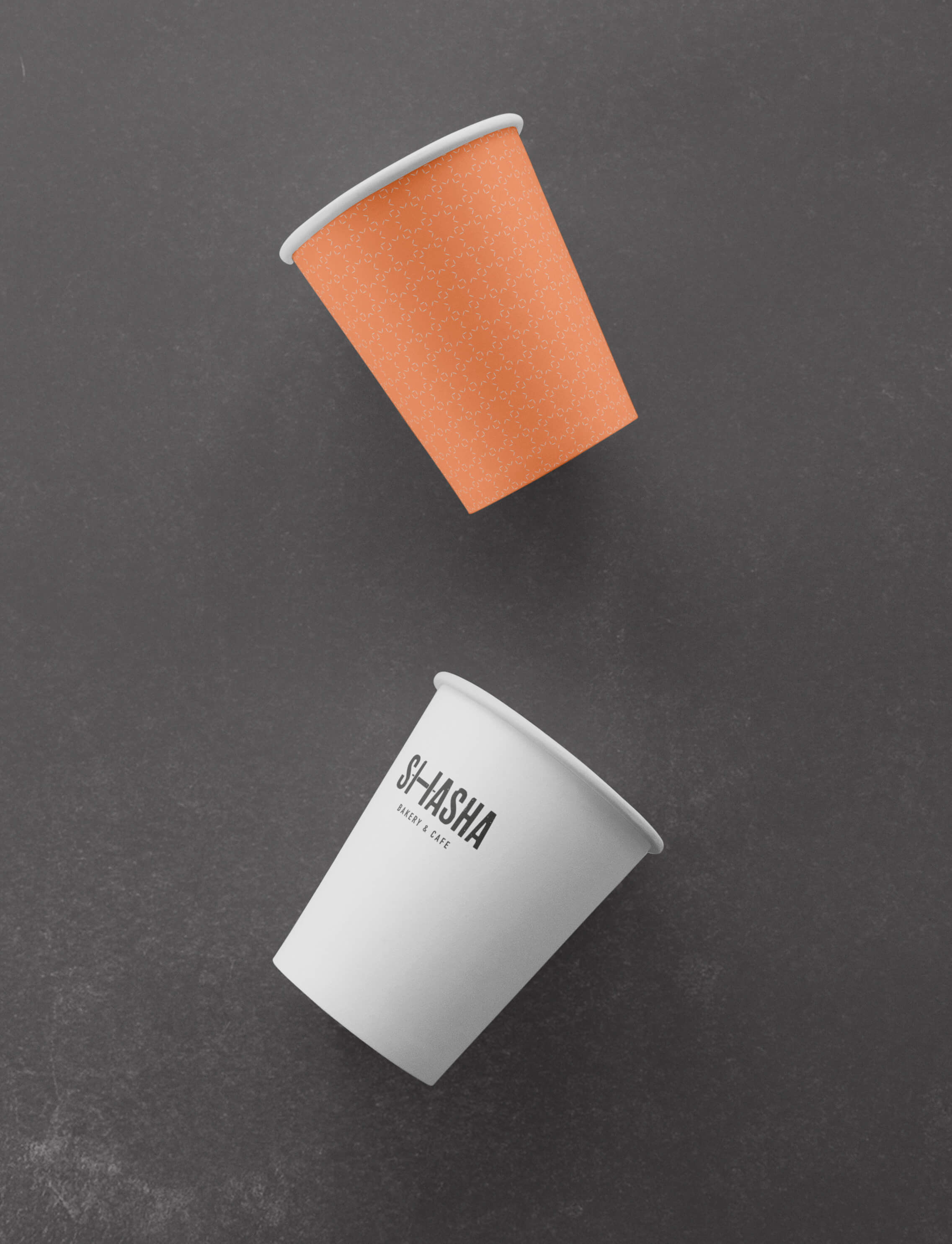 A close up of Sasha Bakery branded coffee cups.